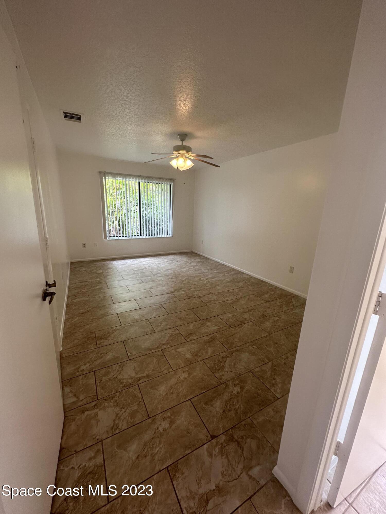 1331 Creel Road Northeast Palm Bay, FL 32905 - Photo 5 of 21 an empty room with windows and closet