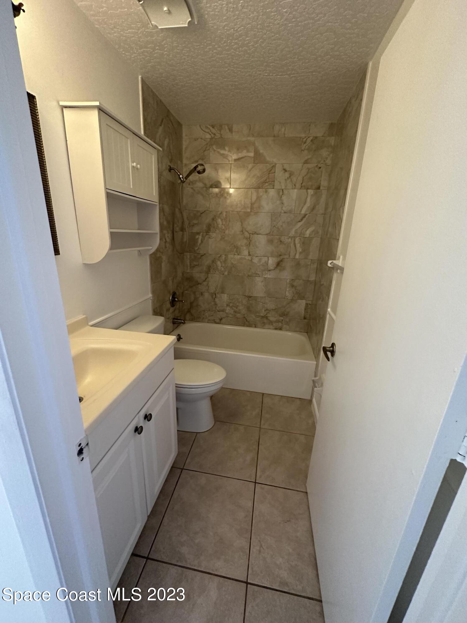 1331 Creel Road Northeast Palm Bay, FL 32905 - Photo 8 of 21 a bathroom with a granite countertop sink toilet and shower