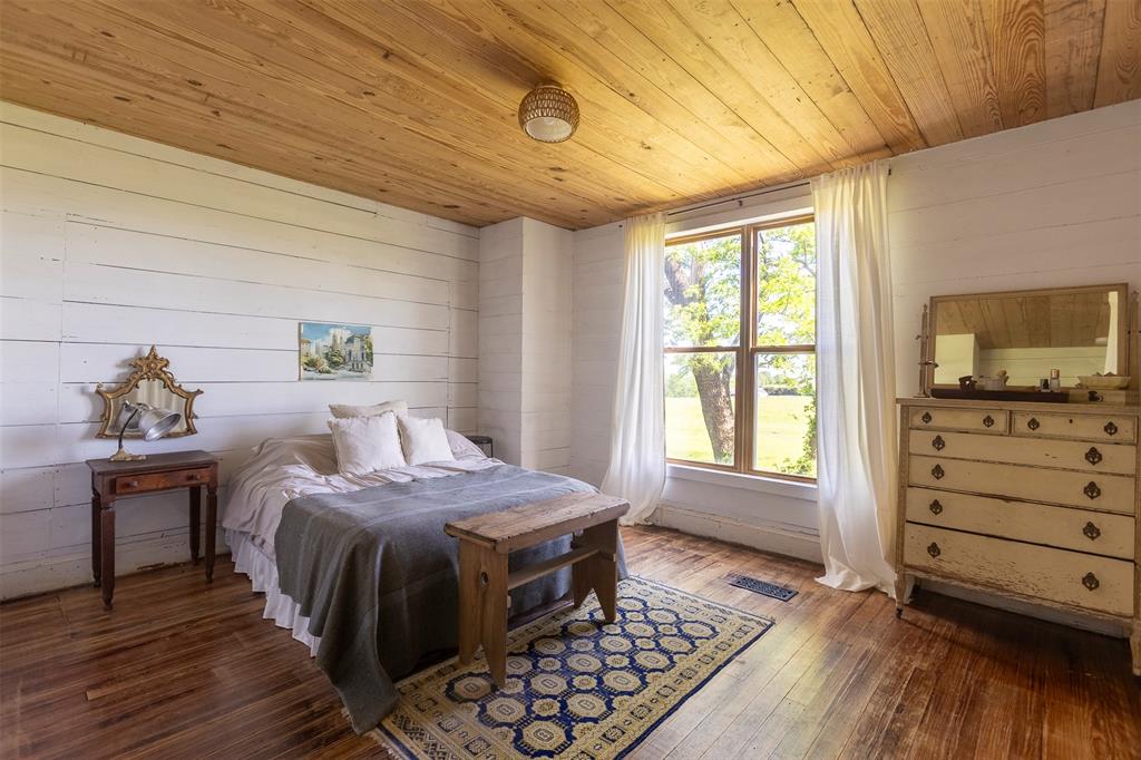 3183 Harrell Road Howe, TX 75459 - Photo 19 of 39 a bedroom with a bed and wooden floor