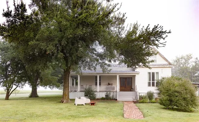 a front view of house with yard space and tree