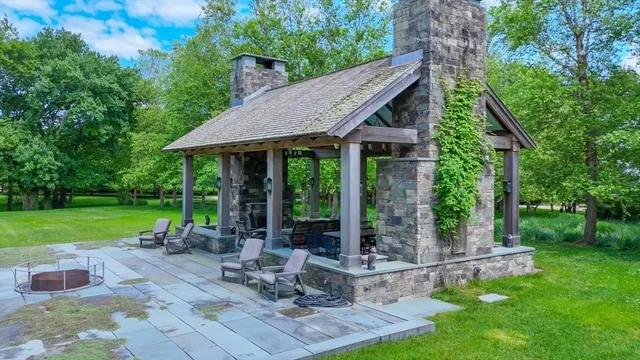 a view of a house with backyard sitting area and garden