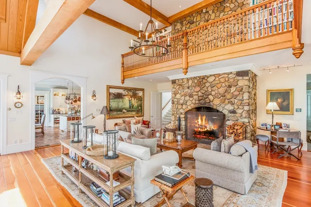 a living room with furniture a fireplace and a table