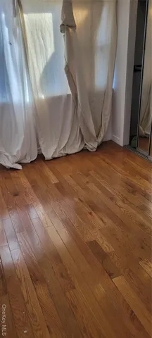 a view of an empty room with kitchen