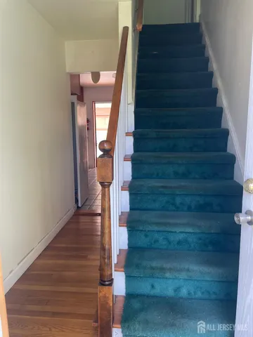 a view of entryway and gallery with wooden floor