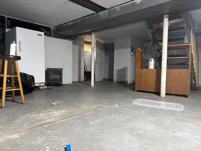 an empty room with furniture and a window