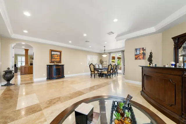 a kitchen with kitchen island granite countertop wooden cabinets and stainless steel appliances