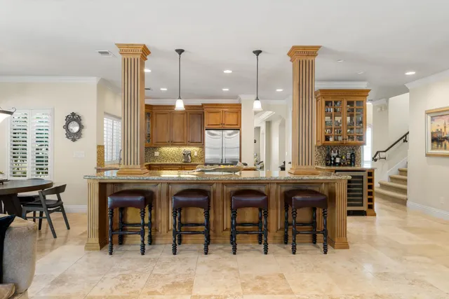a kitchen with stainless steel appliances granite countertop a stove a sink and a refrigerator