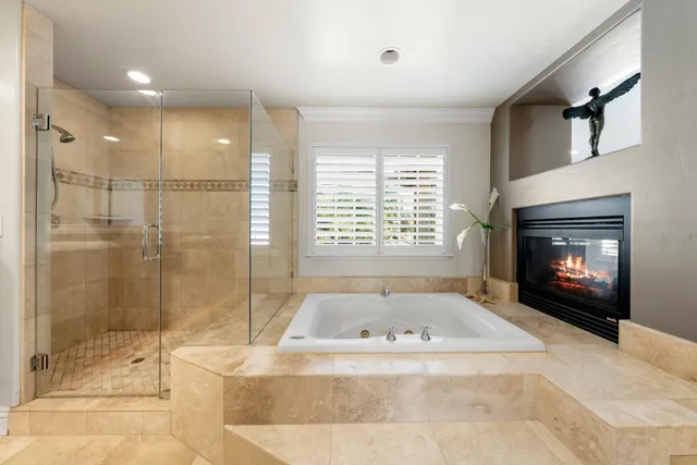 a living room with patio furniture and a garden