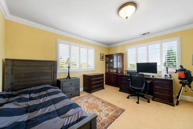 a view of a swimming pool with a patio and plants