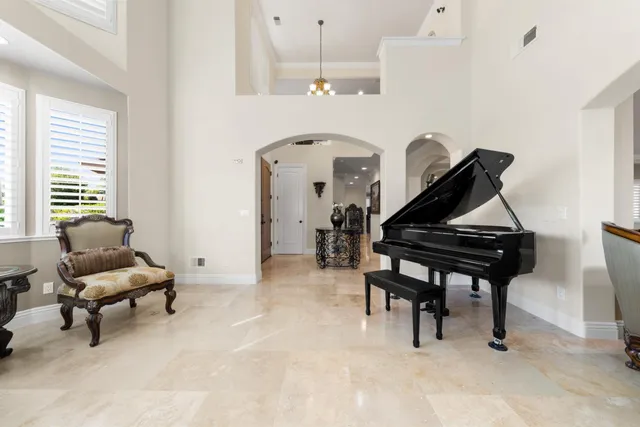 a living room with furniture large window and fire pit