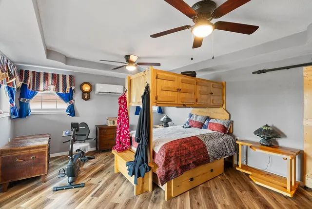 a bedroom with a bed and a chandelier