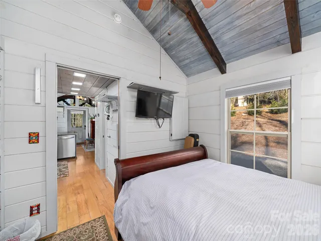 a bedroom with a bed and a large window