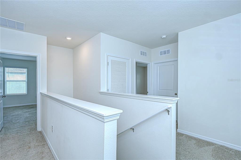 1382 Crescent Hoop Way Wesley Chapel, FL 33543 - Photo 12 of 27 a view of hallway with window
