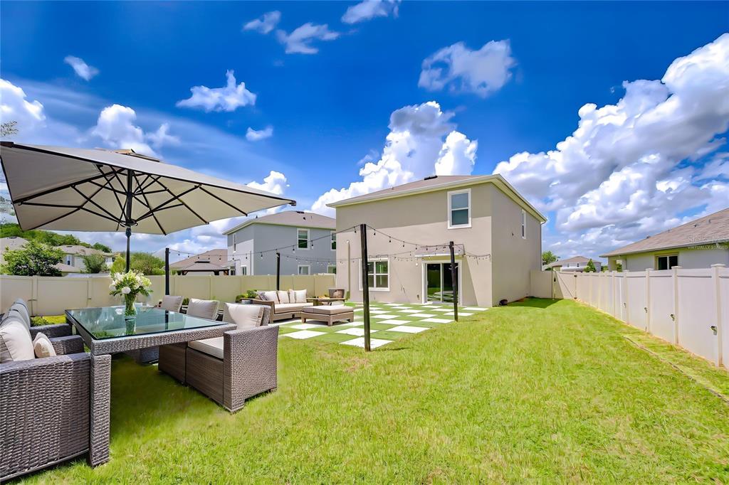 1382 Crescent Hoop Way Wesley Chapel, FL 33543 - Photo 2 of 27 a view of a swimming pool with a patio