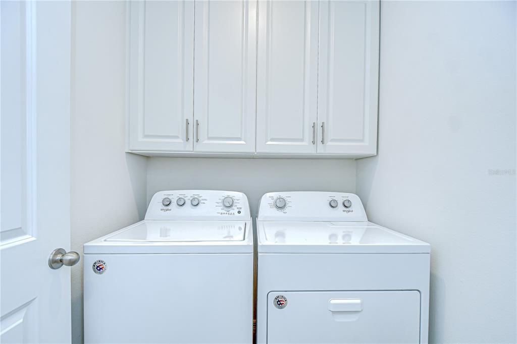 1382 Crescent Hoop Way Wesley Chapel, FL 33543 - Photo 22 of 27 a utility room with dryer and washer
