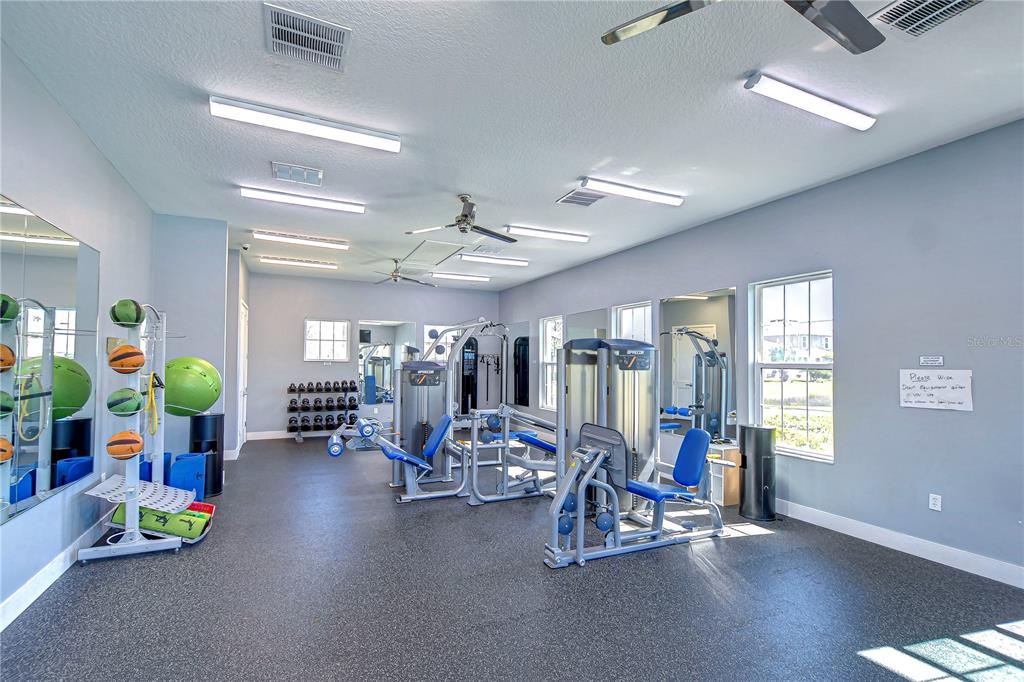 1382 Crescent Hoop Way Wesley Chapel, FL 33543 - Photo 25 of 27 a view of a room with gym equipment