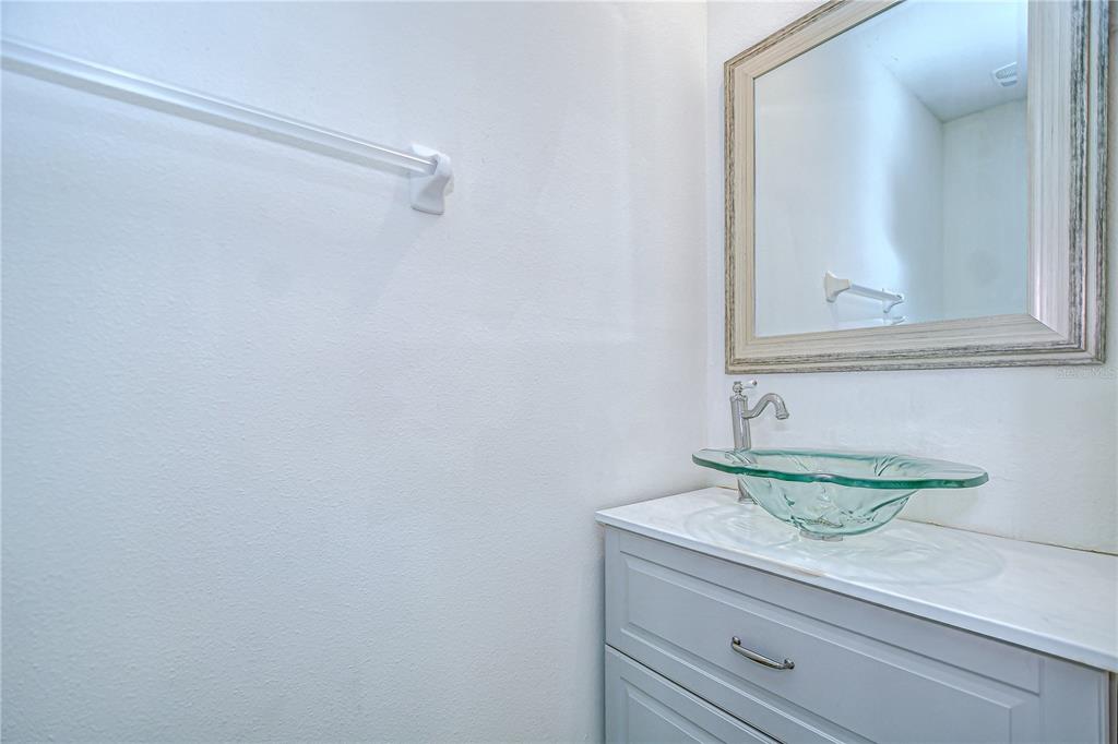 1382 Crescent Hoop Way Wesley Chapel, FL 33543 - Photo 4 of 27 a bathroom with a sink and a mirror