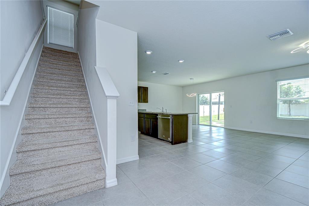 1382 Crescent Hoop Way Wesley Chapel, FL 33543 - Photo 5 of 27 wooden floor in an empty room with a window