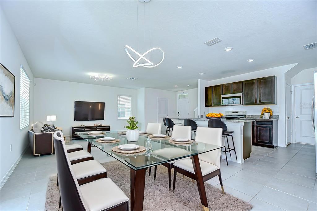 1382 Crescent Hoop Way Wesley Chapel, FL 33543 - Photo 6 of 27 a view of a dining room with furniture