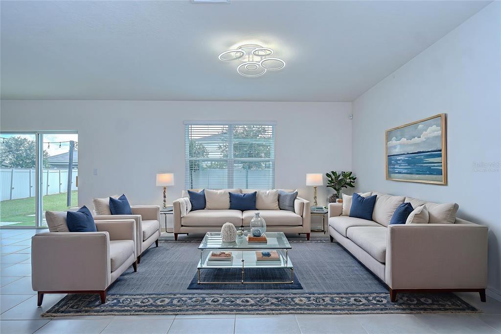 1382 Crescent Hoop Way Wesley Chapel, FL 33543 - Photo 7 of 27 a living room with furniture and a large window