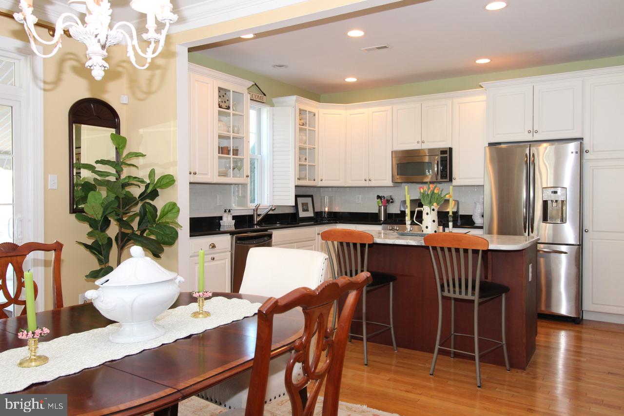 117 West 5th Street Media, PA 19063 - Photo 11 of 54 a kitchen with stainless steel appliances granite countertop a dining table chairs refrigerator and sink
