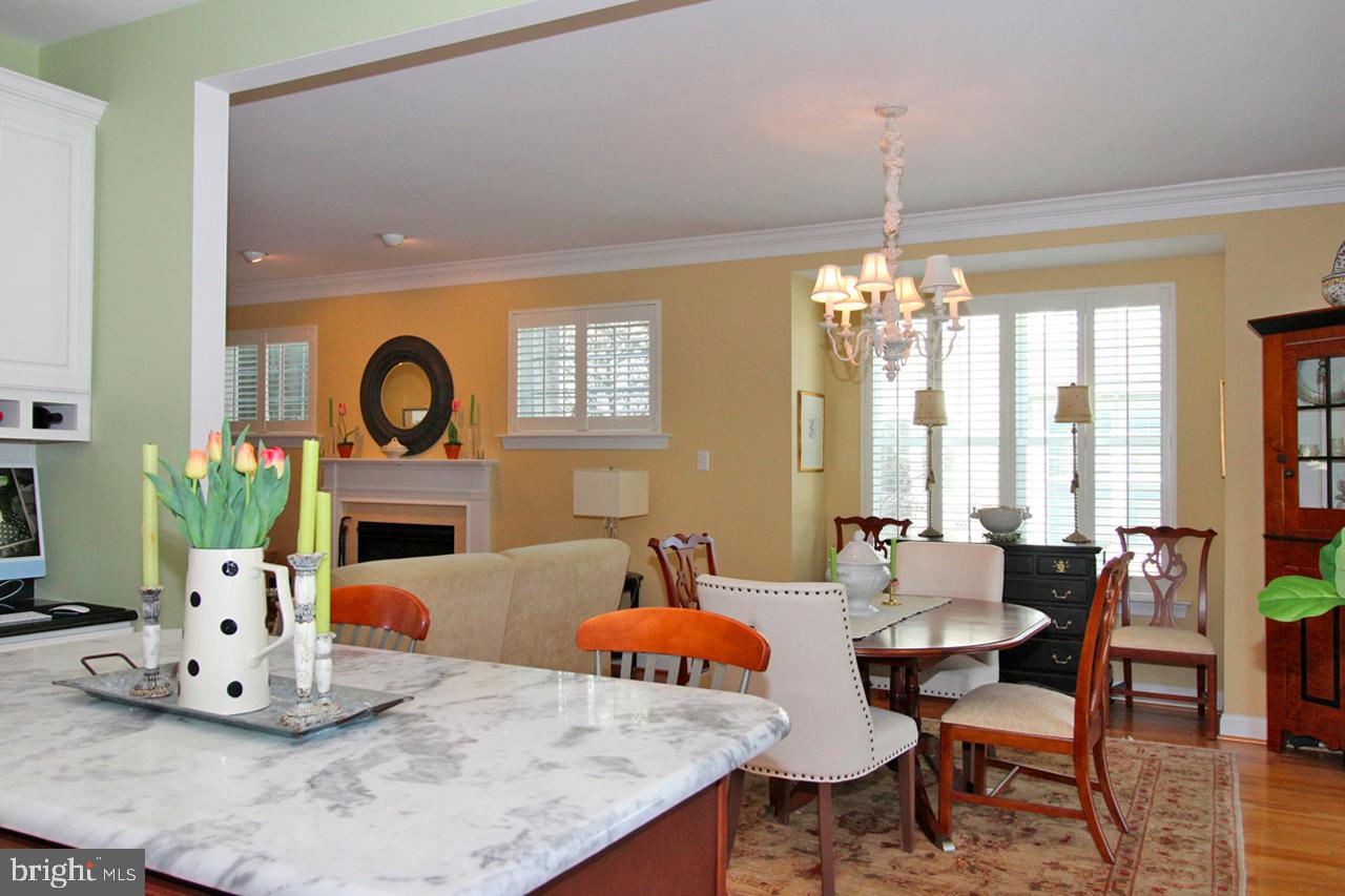 117 West 5th Street Media, PA 19063 - Photo 13 of 54 a dining room with wooden floor a chandelier a wooden table and chairs