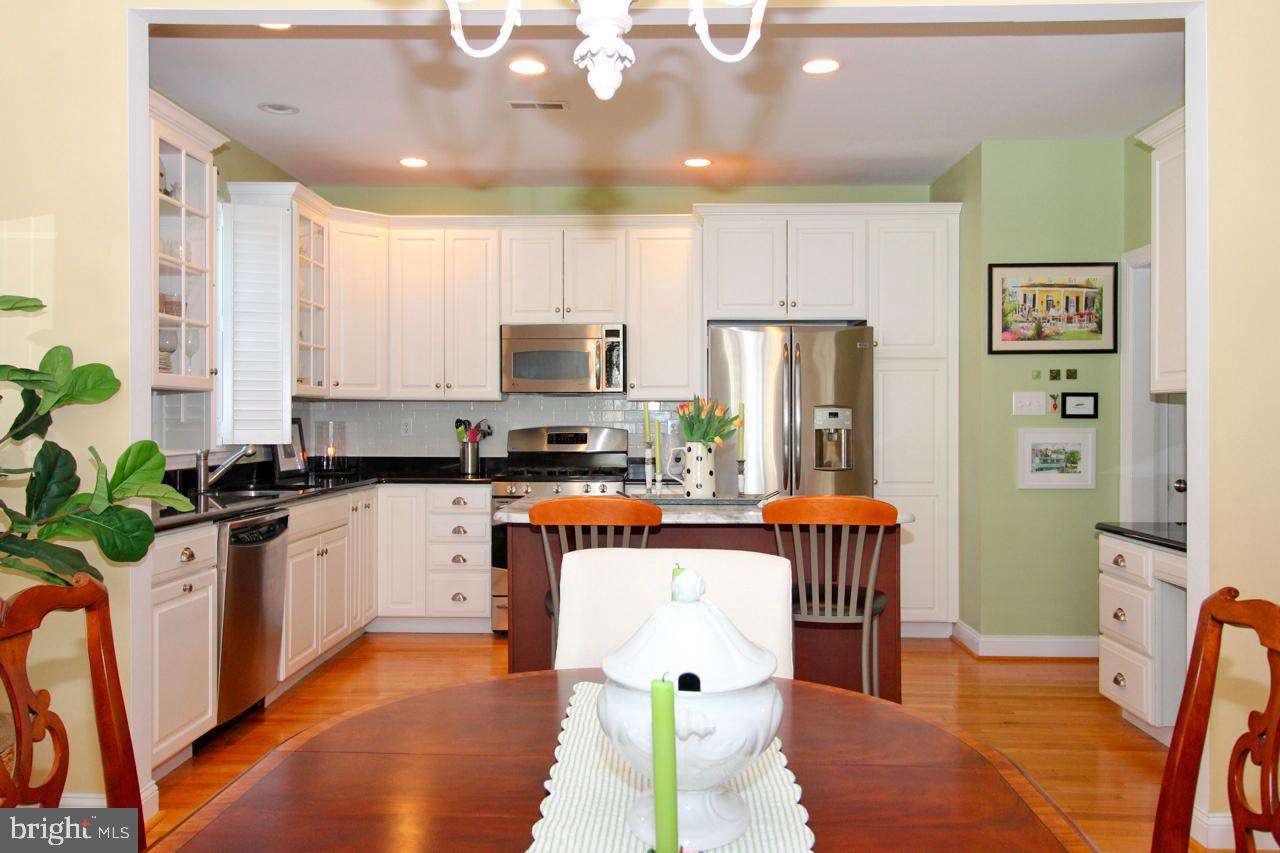 117 West 5th Street Media, PA 19063 - Photo 14 of 54 a kitchen with stainless steel appliances kitchen island granite countertop a refrigerator a stove top oven a sink with dining table and chairs