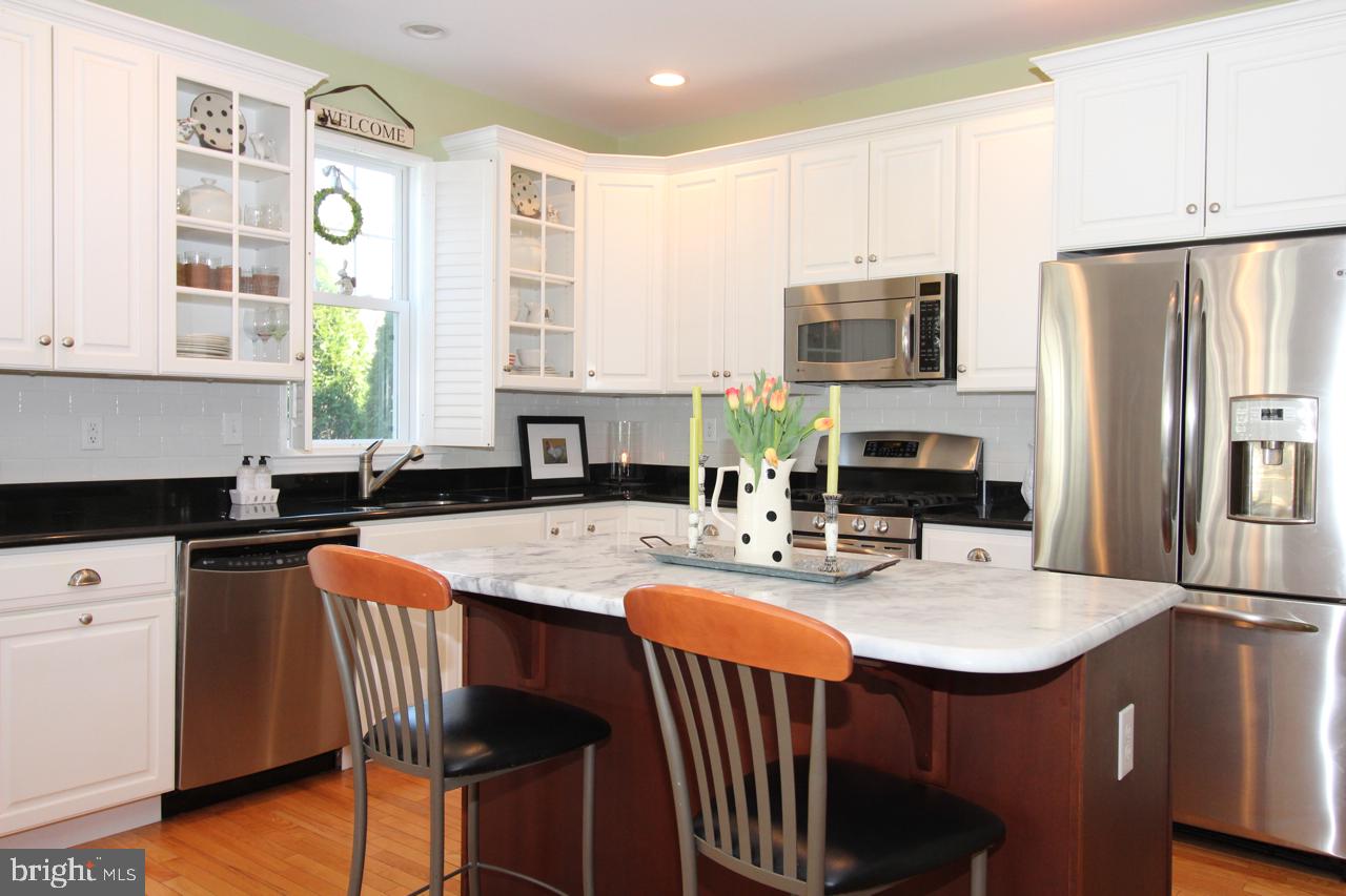 117 West 5th Street Media, PA 19063 - Photo 15 of 54 a kitchen with stainless steel appliances granite countertop a sink a stove a refrigerator cabinets and chairs
