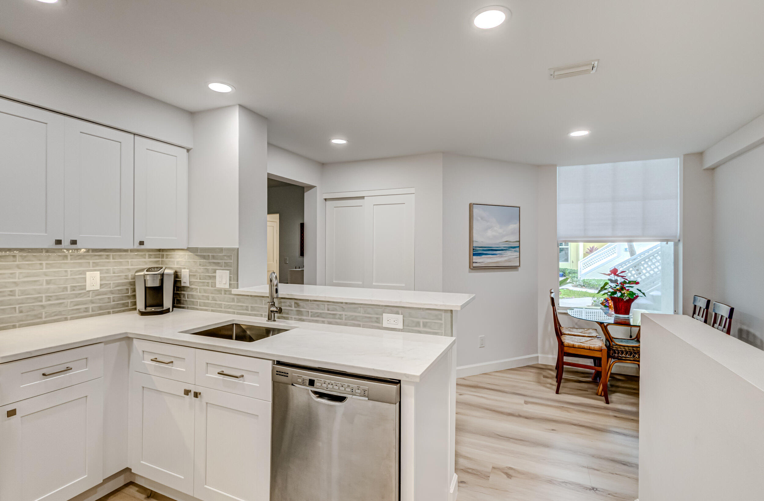 207 Mainsail Circle Jupiter, FL 33477 - Photo 13 of 56 a kitchen that has a sink cabinets and wooden floor