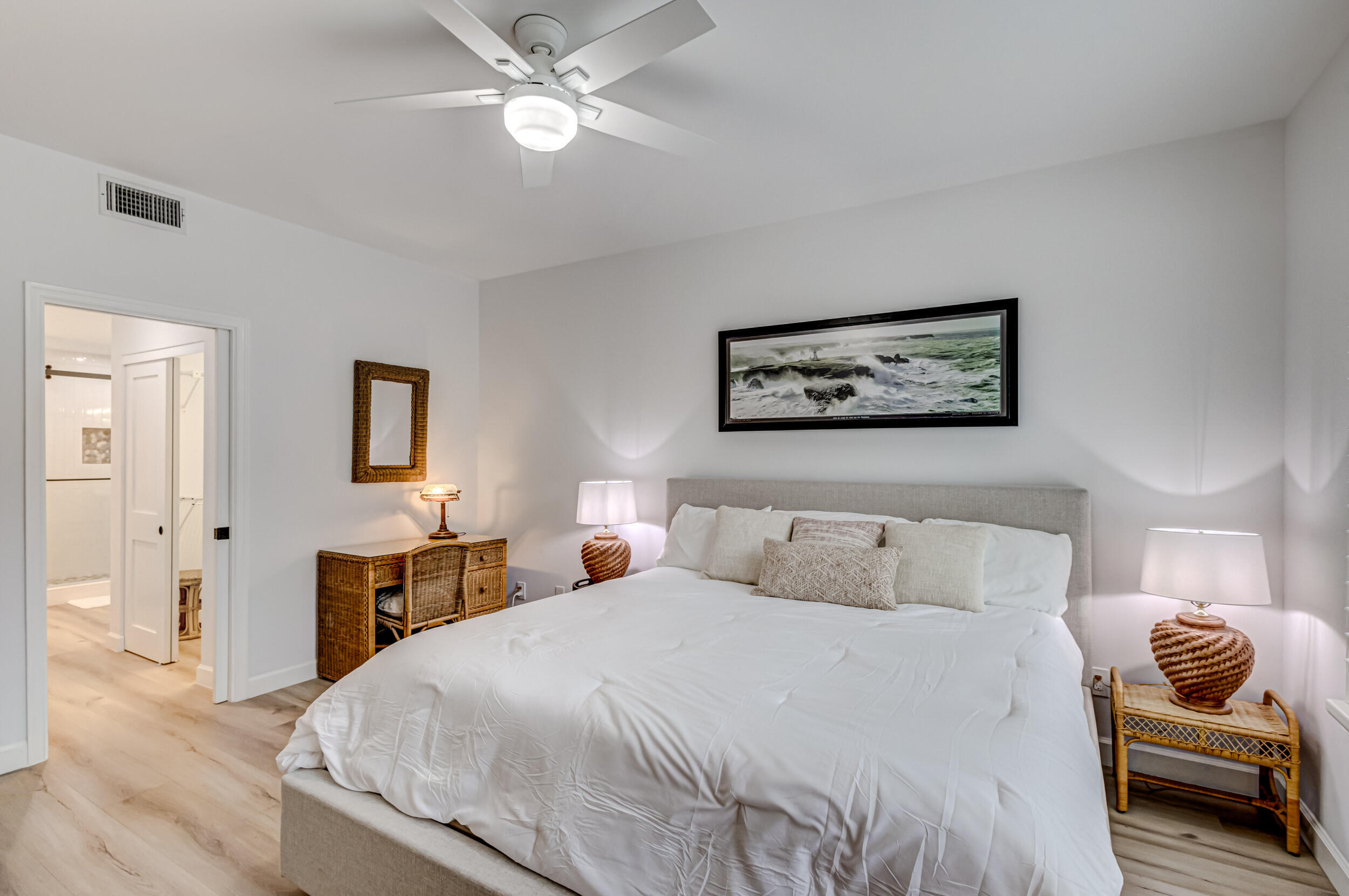 207 Mainsail Circle Jupiter, FL 33477 - Photo 23 of 56 a bedroom with a bed and a chandelier