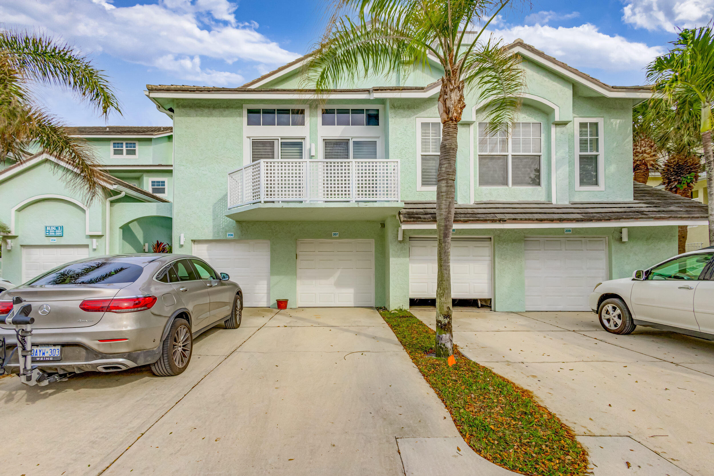 207 Mainsail Circle Jupiter, FL 33477 - Photo 3 of 56 a car parked in front of a house