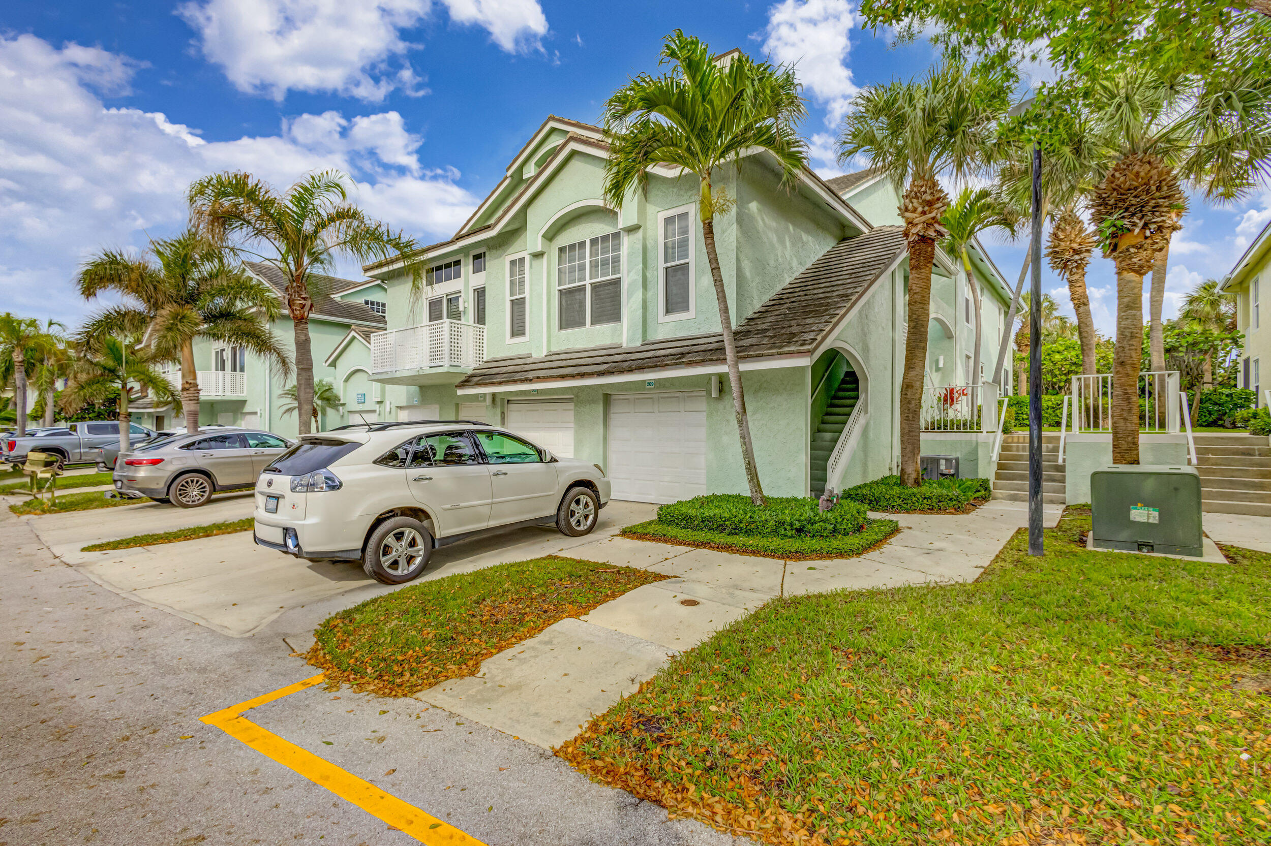 207 Mainsail Circle Jupiter, FL 33477 - Photo 4 of 56 a front view of a house with garden