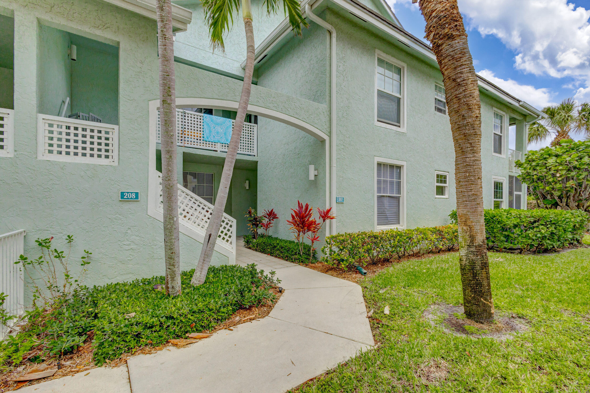 207 Mainsail Circle Jupiter, FL 33477 - Photo 5 of 56 a front view of a house with garden