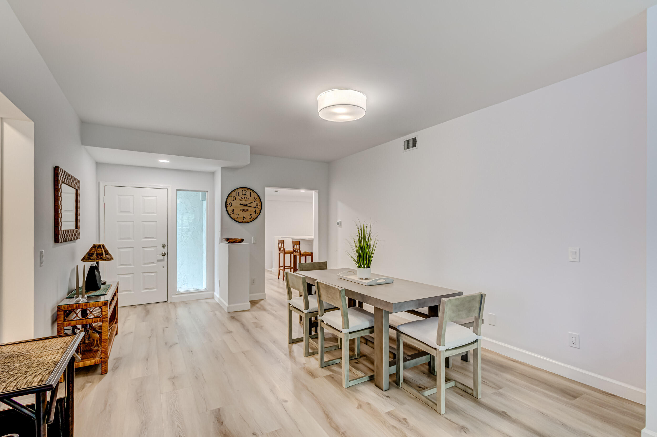 207 Mainsail Circle Jupiter, FL 33477 - Photo 8 of 56 a view of a dining room with furniture and wooden floor
