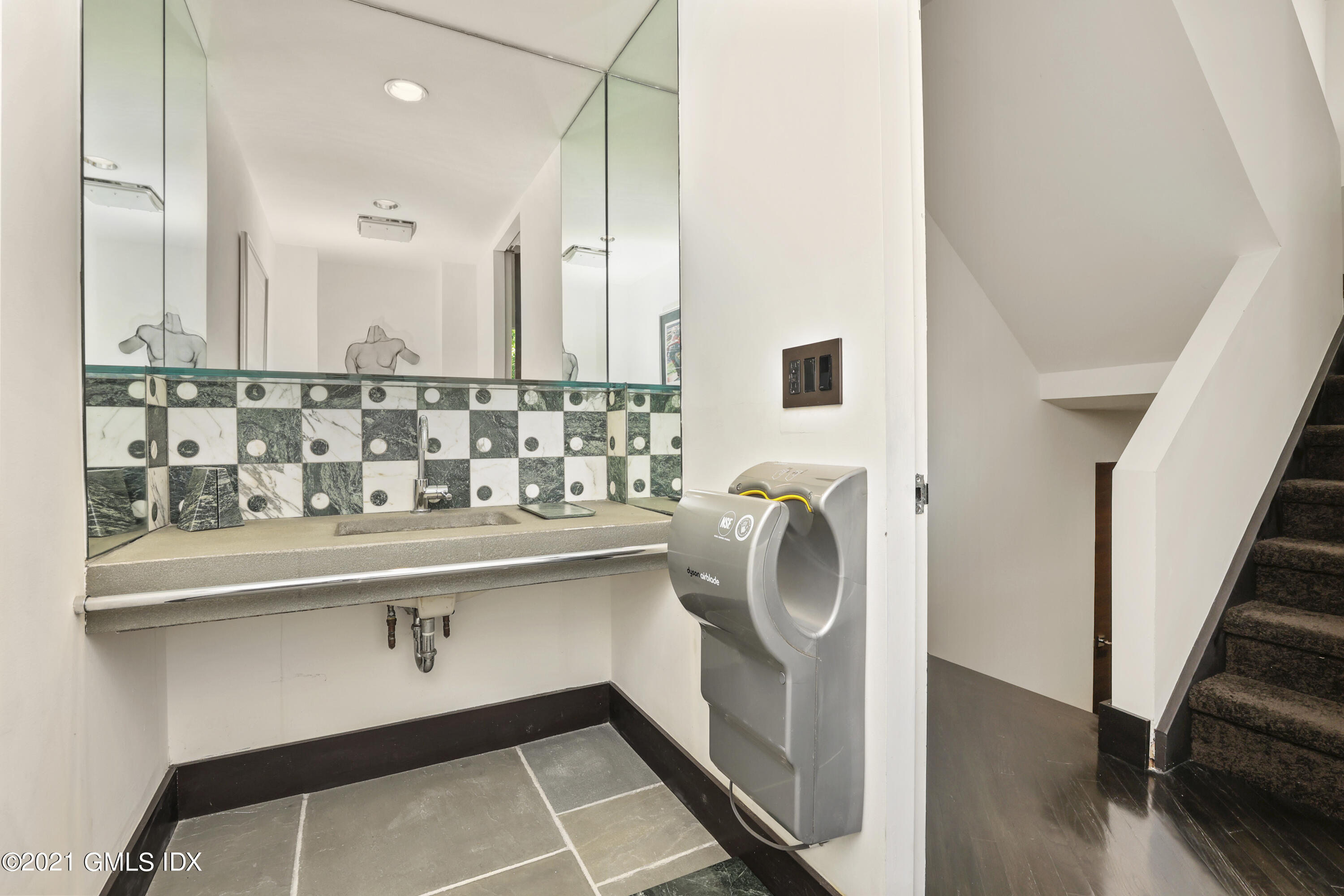 49 Mill Brook Road, Unit WEST Stamford, CT 06902 - Photo 14 of 37 a bathroom with a sink and mirror