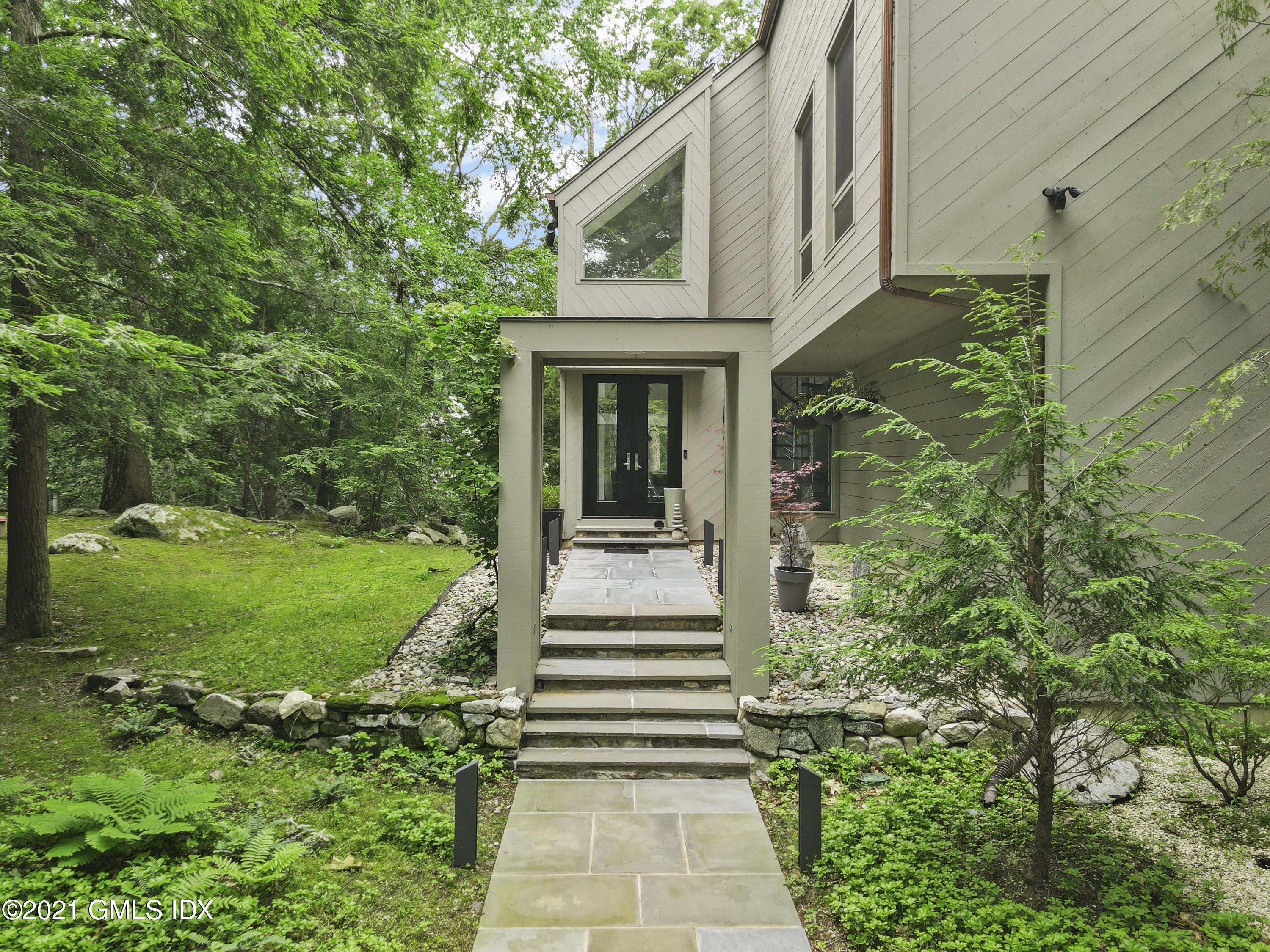 49 Mill Brook Road, Unit WEST Stamford, CT 06902 - Photo 2 of 37 a view of a pathway of a house with a garden