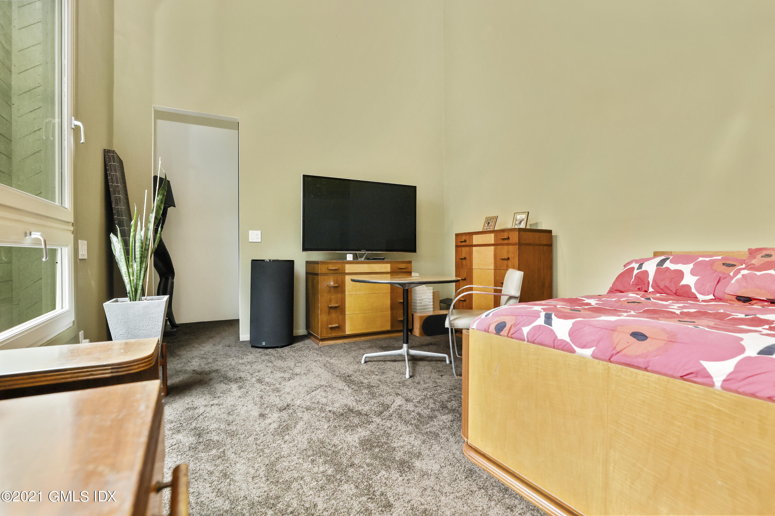 49 Mill Brook Road, Unit WEST Stamford, CT 06902 - Photo 22 of 37 a bedroom with a bed and a flat screen tv