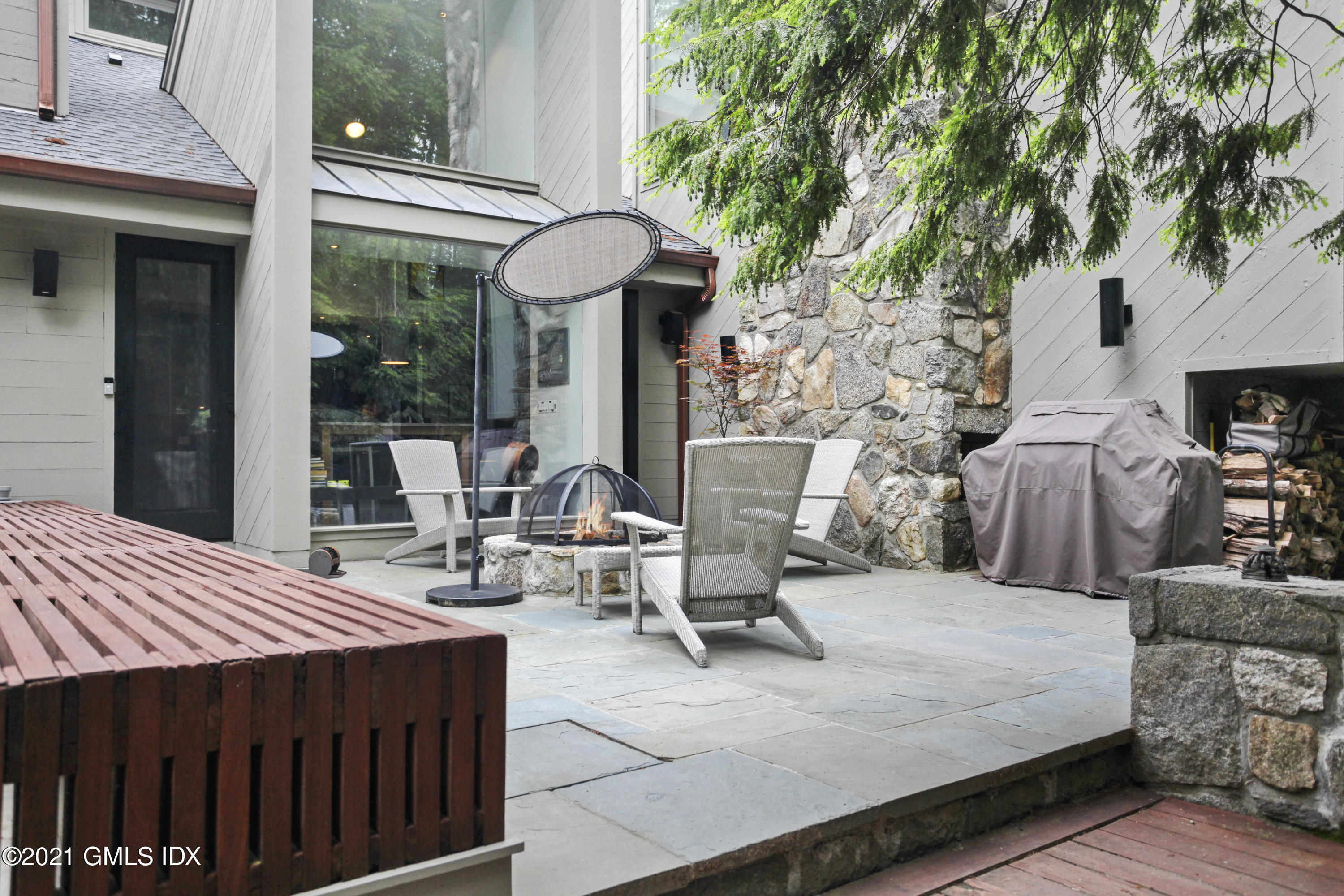 49 Mill Brook Road, Unit WEST Stamford, CT 06902 - Photo 27 of 37 a view of a patio with table and chairs and potted plants