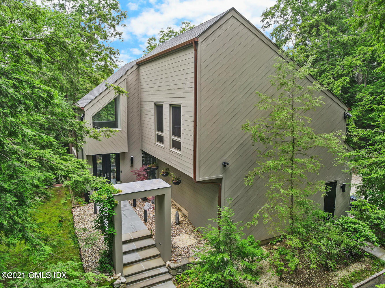 49 Mill Brook Road, Unit WEST Stamford, CT 06902 - Photo 3 of 37 a view of a house with brick walls and plants