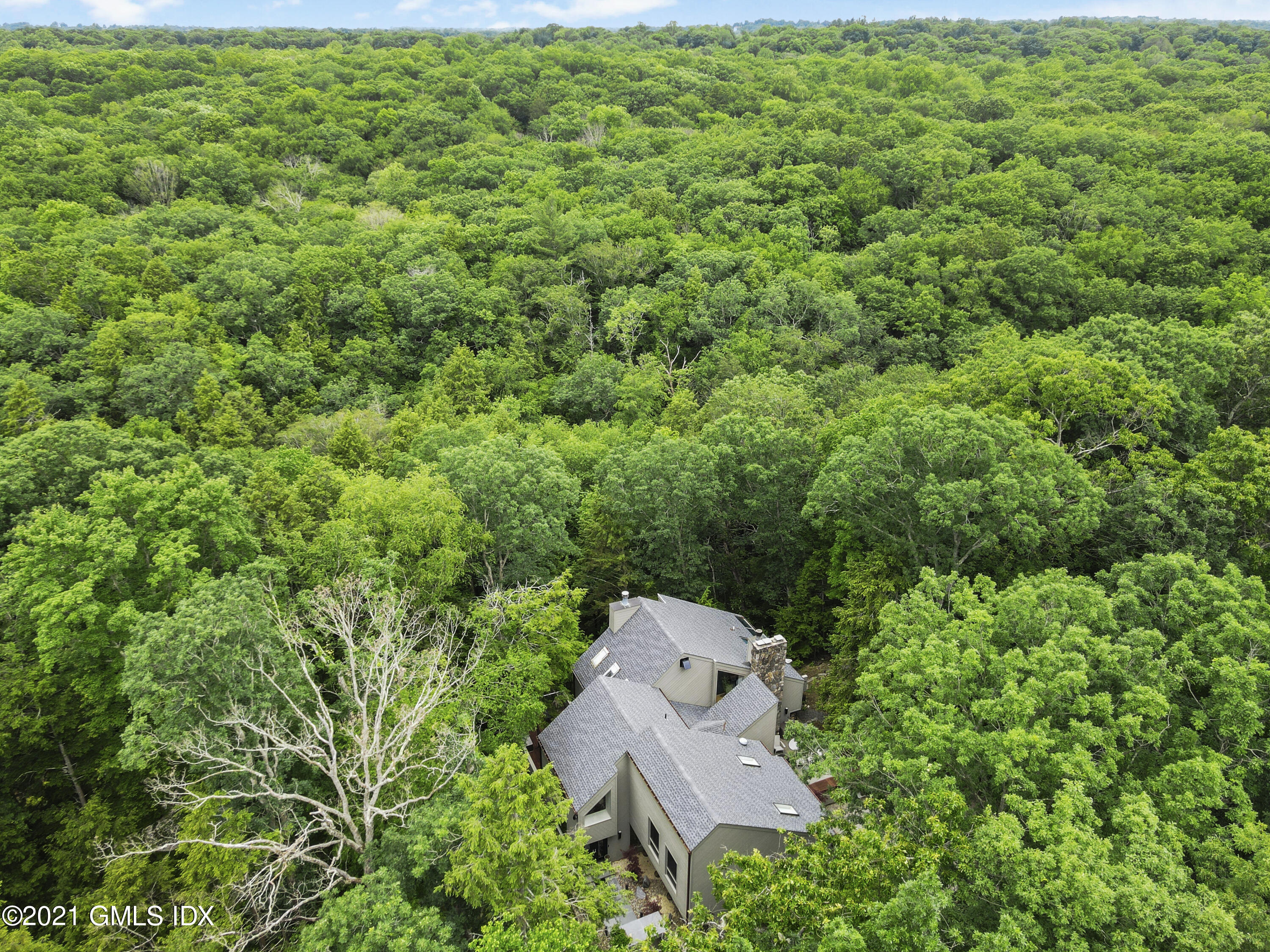 49 Mill Brook Road, Unit WEST Stamford, CT 06902 - Photo 37 of 37 an aerial view of a house with a yard