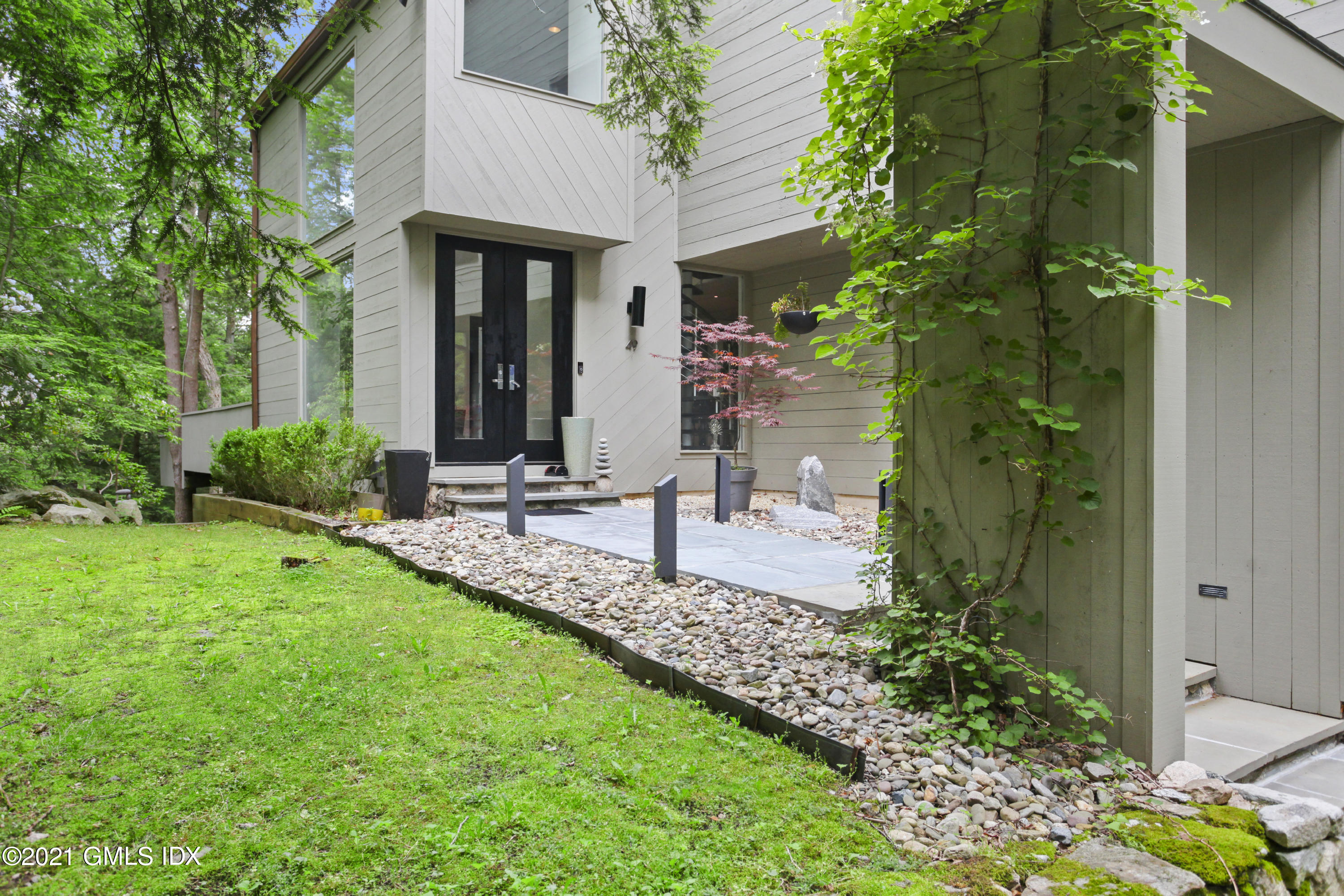 49 Mill Brook Road, Unit WEST Stamford, CT 06902 - Photo 5 of 37 a view of a building with a garden