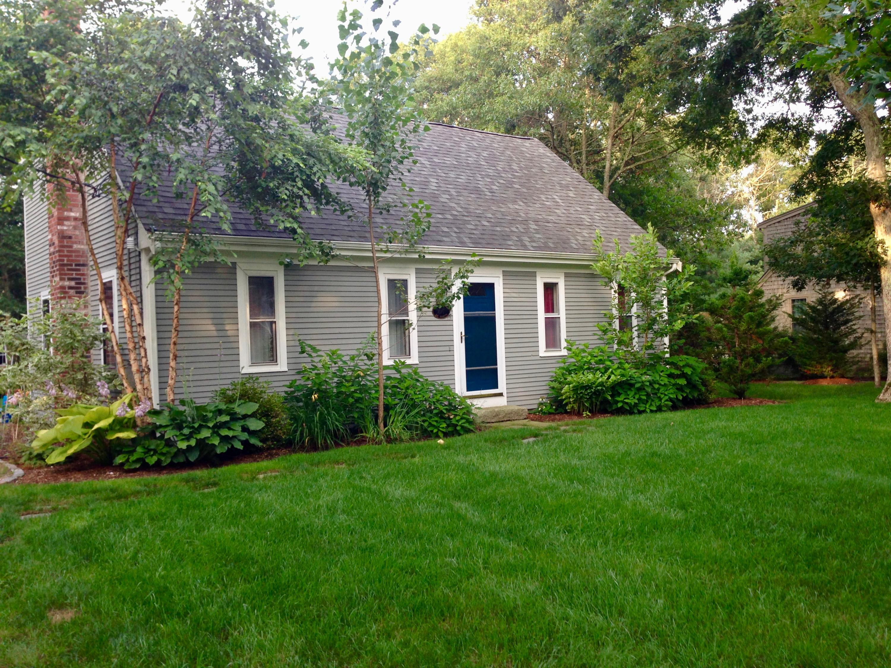 a view of an house with backyard space and garden
