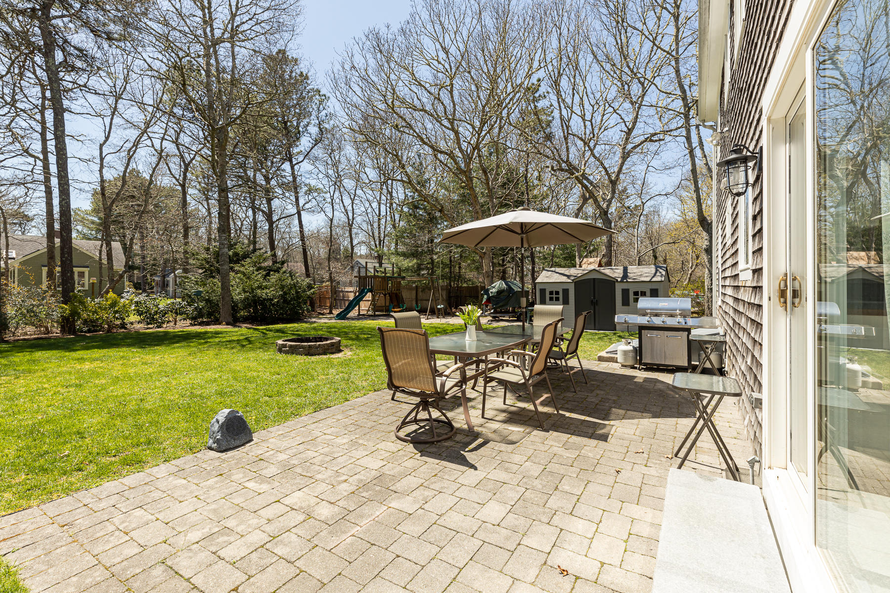 29 Hitching Post Lane Centerville, MA 02632 - Photo 25 of 29 a view of a table and chairs under an umbrella
