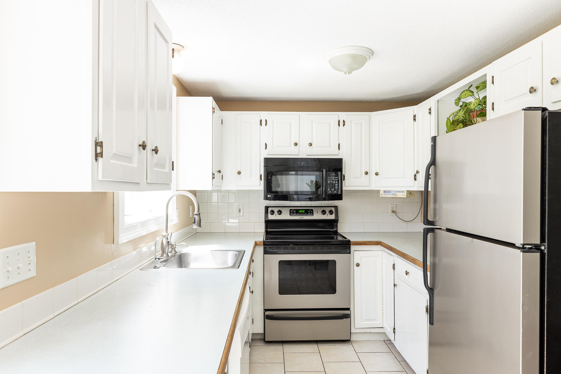 29 Hitching Post Lane Centerville, MA 02632 - Photo 6 of 29 a kitchen with stainless steel appliances a refrigerator sink and white cabinets
