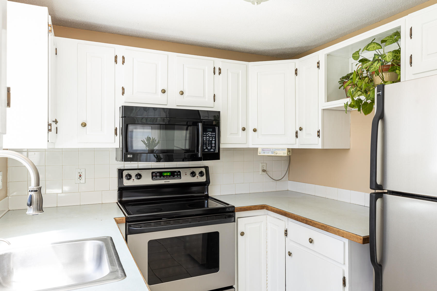 29 Hitching Post Lane Centerville, MA 02632 - Photo 7 of 29 a kitchen with granite countertop a white stove top oven and refrigerator