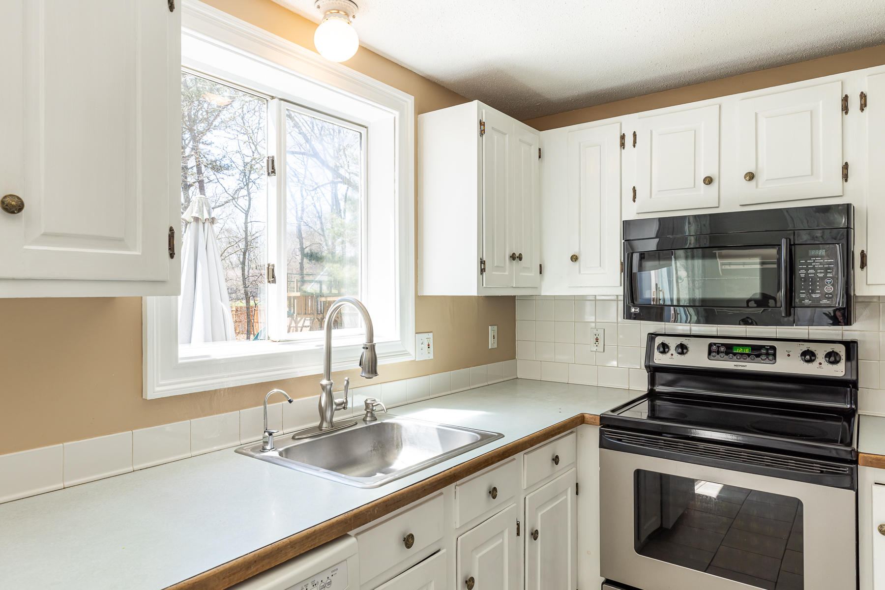 29 Hitching Post Lane Centerville, MA 02632 - Photo 8 of 29 a kitchen with granite countertop a sink and a stove top oven