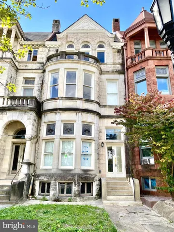 a front view of a residential apartment building with a yard
