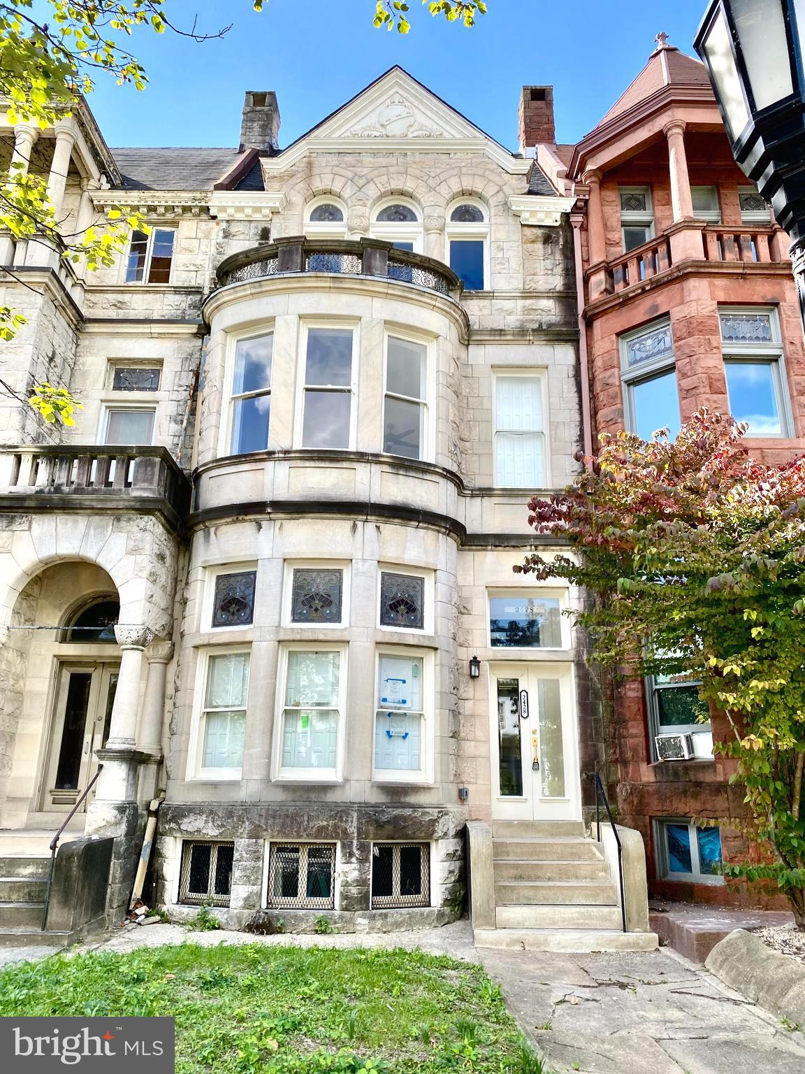 a front view of a residential apartment building with a yard