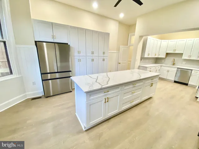a kitchen with stainless steel appliances a refrigerator and a stove