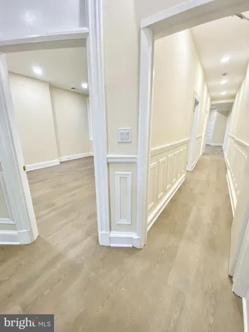 an empty room with wooden cabinet and windows